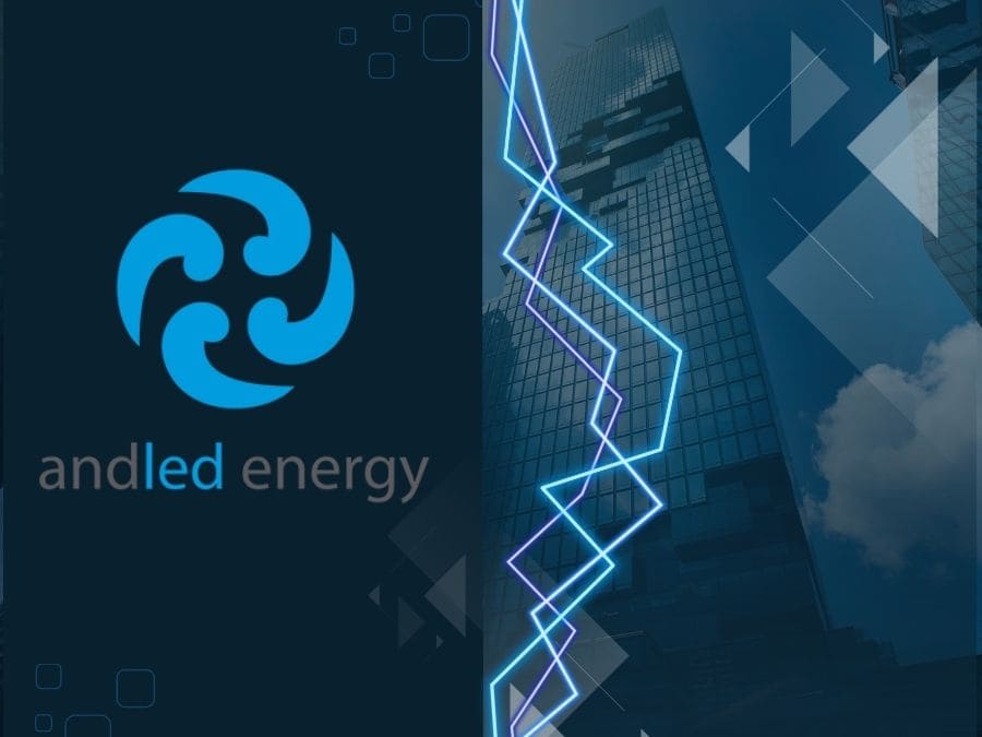 Imagen que contiene el logo de Andled Energy, un edificio de oficinas y unos haces de luz